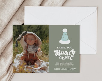 May include: A green thank you card with a blue and white party hat illustration. The text reads "Thank you Beary much for making my 1st birthday so special! With love, Henry."
