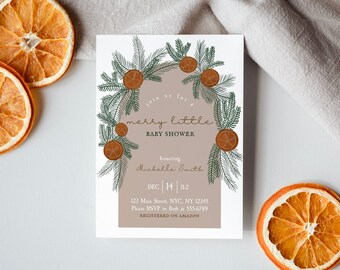 Könnte beinhalten: Eine weiße Karte mit einer braunen und grünen Illustration eines Kranzes mit Orangen. Der Text auf der Karte lautet "Join us for a merry little baby shower honoring Michelle Smith Dec 14 112 123 Main Street, NYC, NY 12345 Please RSVP to Beth at 555-6799 REGISTERED ON AMAZON"