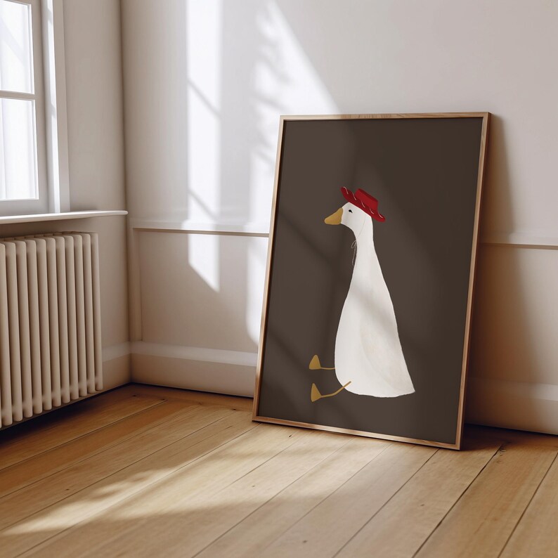 May include: A white goose wearing a red hat sits on a dark brown background. The goose has yellow feet and a long neck.