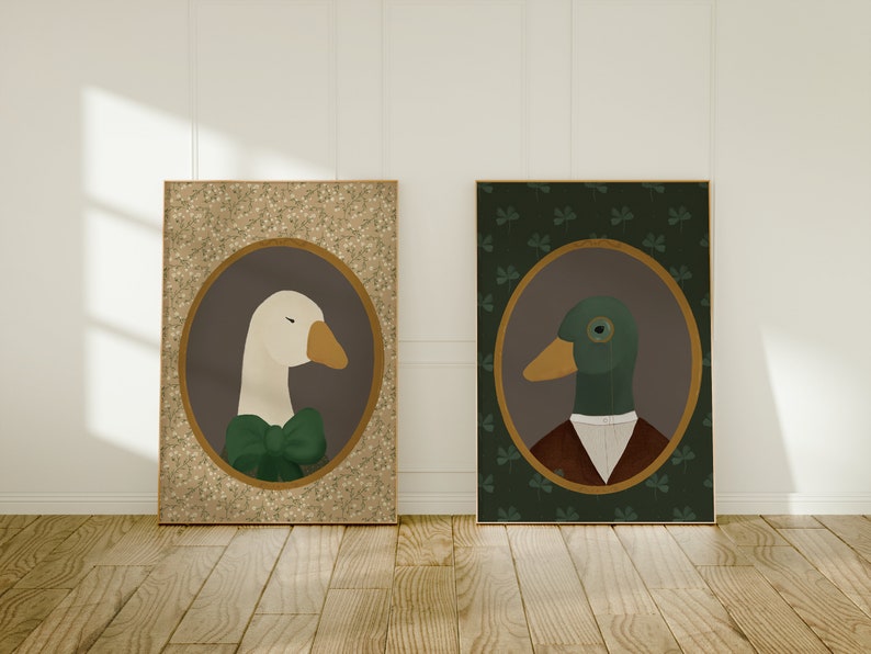 May include: Two framed illustrations of animals in a vintage style. The first illustration features a white goose wearing a green bow tie against a gold background with a white floral pattern. The second illustration features a green duck wearing a brown vest and a monocle against a green background with a shamrock pattern.