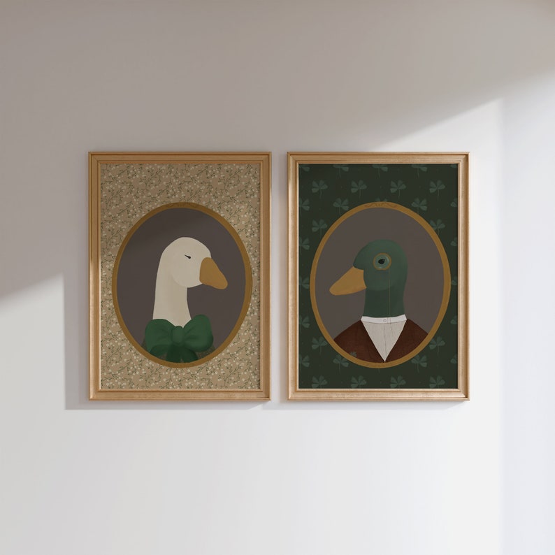 May include: Two framed illustrations of a goose and a duck wearing formal attire. The goose is white with a green bow tie and the duck is green with a brown vest and a white collar. Both illustrations are set against a background of green shamrocks.