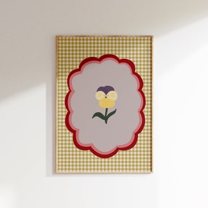 May include: A yellow, purple, and green flower with a smiling face is centered on a light purple background. The background is surrounded by a red, pink, and white scalloped border. The border is on a yellow and white gingham background.