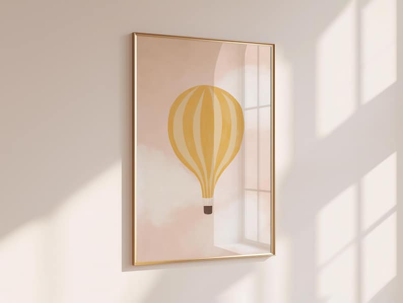 May include: A framed print of a yellow and white striped hot air balloon against a pink and white cloudy background.