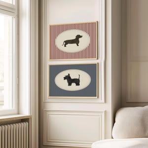 May include: Two framed dog art prints. The top print features a dachshund silhouette on an oval against a red and white striped background. The bottom print shows a terrier silhouette on an oval against a blue and white striped background.