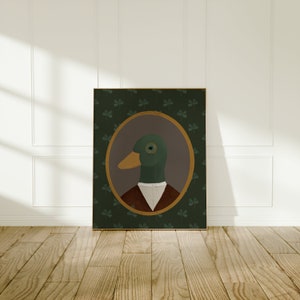 May include: A framed illustration of a duck wearing a white collared shirt and a brown vest. The duck has a monocle and is set against a green background with shamrock designs.