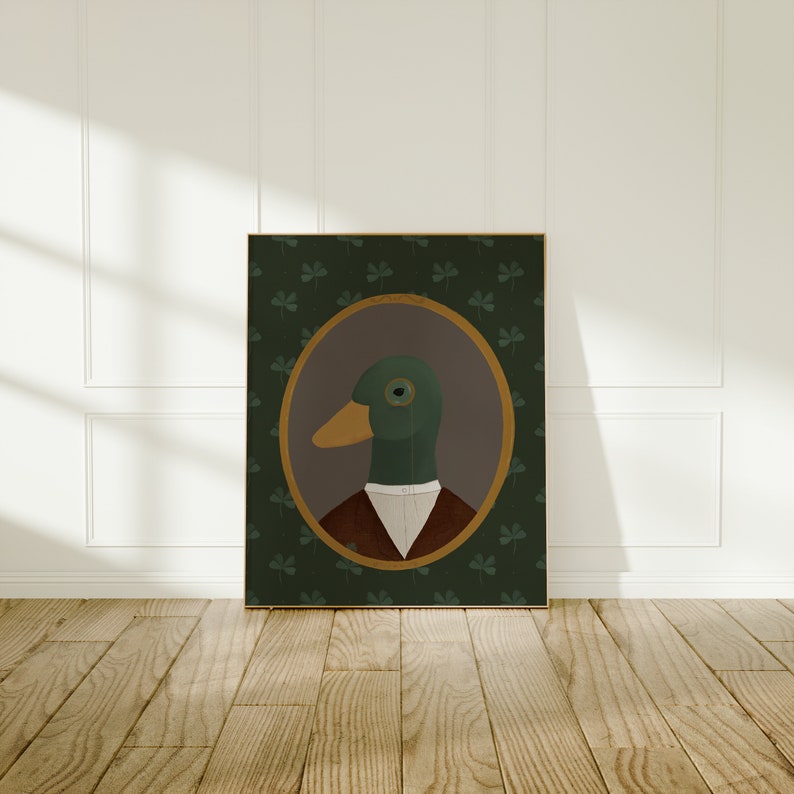 May include: A framed illustration of a duck wearing a white collared shirt and a brown vest. The duck has a monocle and is set against a green background with shamrock designs.
