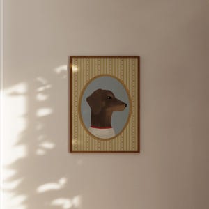 May include: A framed portrait of a dachshund dog in profile. The dog is brown with a red collar and a white shirt, set against a light blue oval. The background features vertical stripes in beige and white, framed in a wooden border.