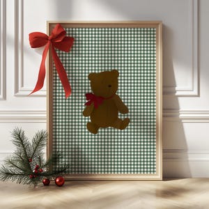 May include: A framed print with a green and white gingham pattern featuring a brown teddy bear with a red bow.