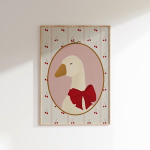 May include: A framed illustration of a white goose with a red bow, set against a background of pink and white stripes with red cherries.