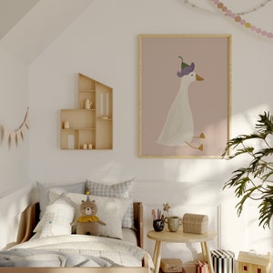 May include: A light brown wooden bed with a white and blue checkered bedspread and a stuffed bear wearing a party hat. The bed is in a child's bedroom with a white wall, a wooden shelf, and a framed print of a goose wearing a purple hat.