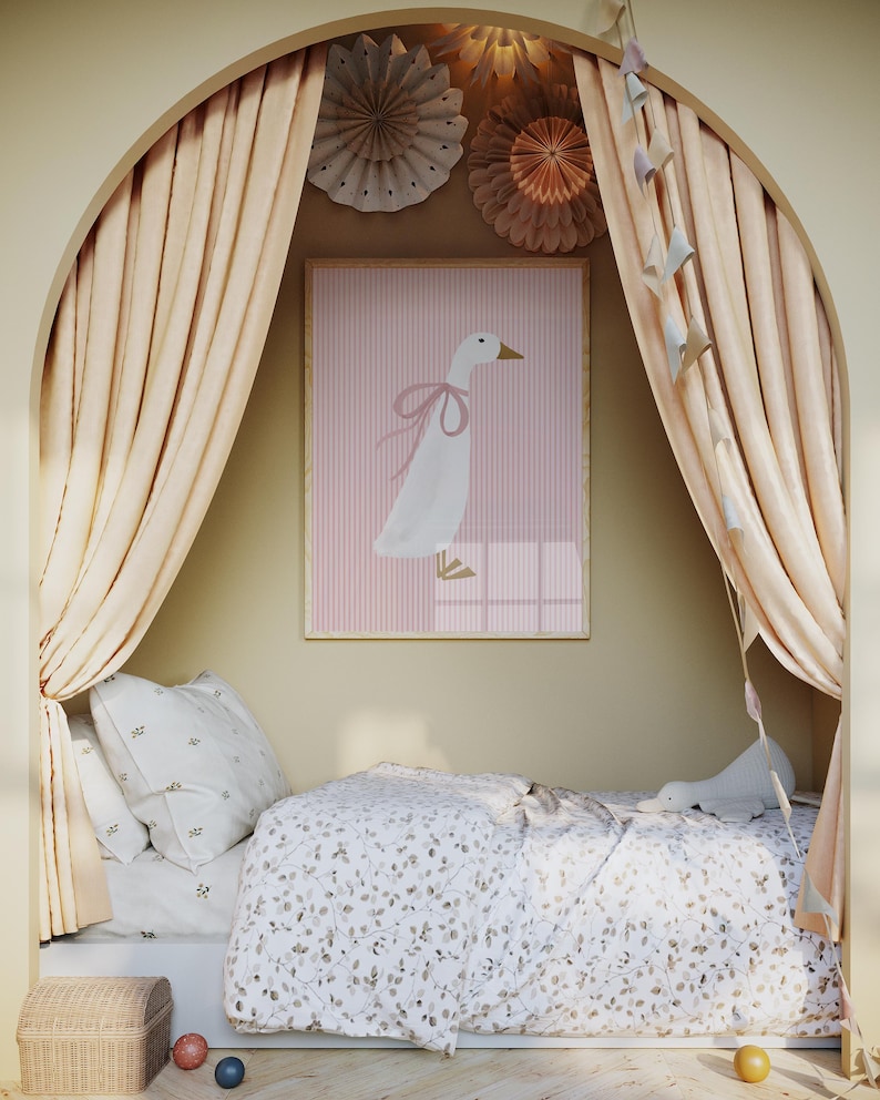 May include: A white goose with a pink bow sits on a pink and white striped background in a framed picture. The picture is hanging on a wall in a room with a bed and curtains.