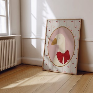 May include: A framed illustration of a white goose with a red bow, set against a background of pink and white cherries on a striped pattern.