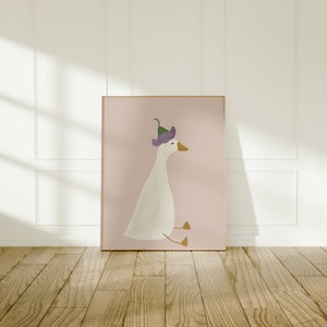 May include: A white goose with a purple flower on its head sits on a pink background. The goose is looking to the right.