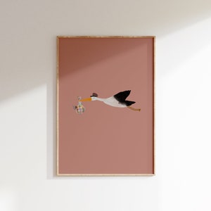 May include: A white stork with a black wingspan flies with a colorful package in its beak against a pink background.