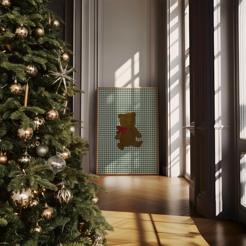 May include: A framed print of a brown teddy bear wearing a red bow on a green and white gingham background.
