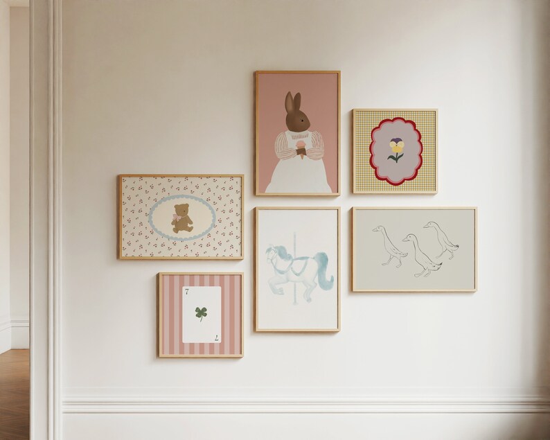 May include: A collection of framed prints with various designs, including a rabbit, a teddy bear, a flower, ducks, and a carousel horse. The prints are all in pastel colors and have a whimsical feel.