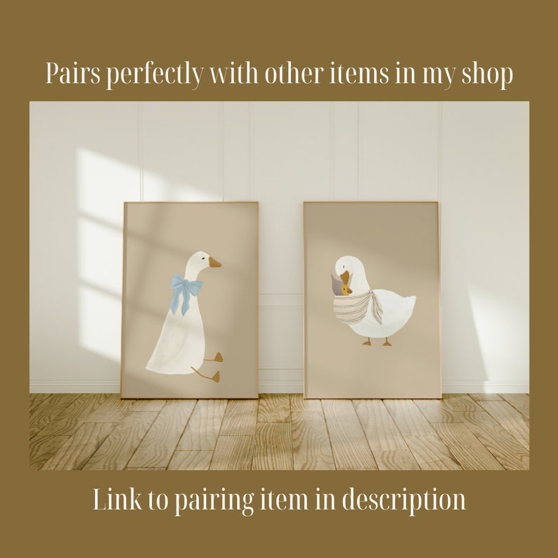 May include: Two framed illustrations of white geese on a beige background. The goose on the left is wearing a blue bow. The goose on the right is holding a small yellow chick in its beak. The text "Pairs perfectly with other items in my shop" is at the top of the image. The text "Link to pairing item in description" is at the bottom of the image.