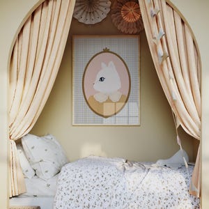 May include: A white bed with a floral patterned duvet cover and a white pillow with a floral pattern. The bed is in a nook with beige curtains and a framed print of a cat with a pink background. There are paper decorations hanging from the ceiling.