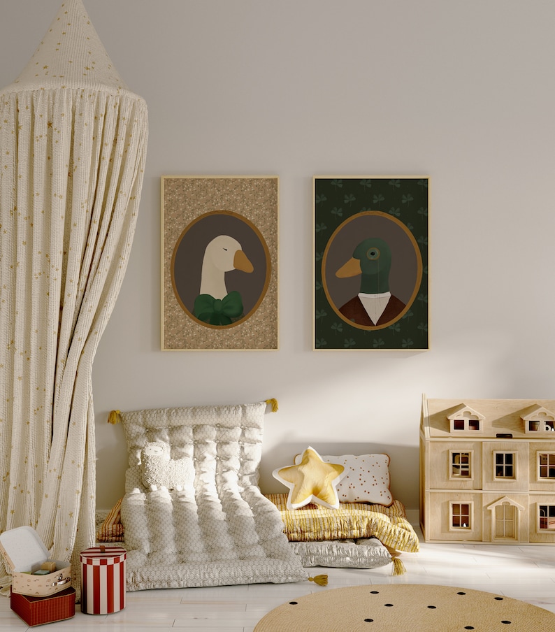May include: Two framed illustrations of a goose and a duck wearing clothing. The goose is white with a green bow tie and the duck is green with a brown jacket and a white collar. The frames are brown and the illustrations are on a beige background.