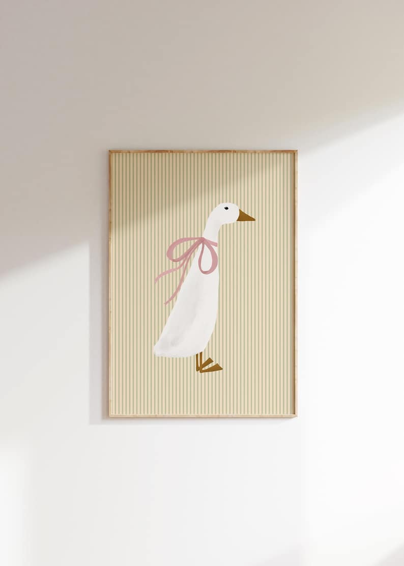 May include: A white goose with a pink bow on its neck, standing on a yellow and white striped background.