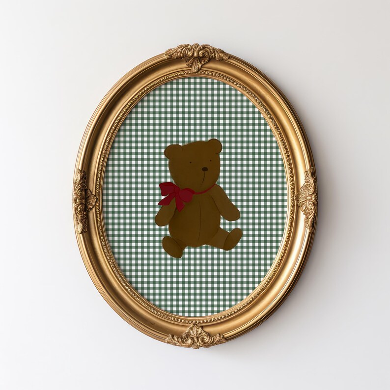 May include: A gold oval frame with a green and white gingham pattern and a brown teddy bear with a red bow.