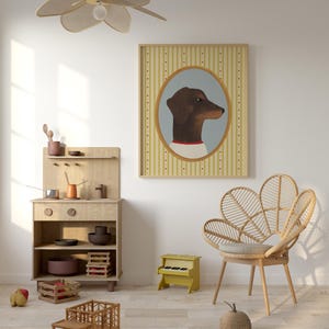 May include: A framed portrait of a dachshund dog in an oval frame hangs above a wooden toy kitchen set, a yellow toy piano, and a wooden truck. A woven chair and a decorative apple are also in the room. A flower-shaped ceiling fan hangs from the ceiling.