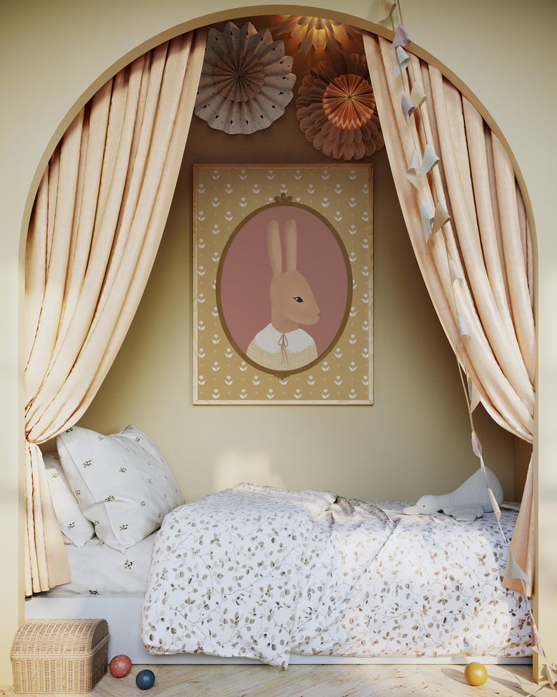 May include: A light brown bunny with a pink oval frame around it is on a poster with a light brown background. The poster is hanging on a wall in a room with a bed and curtains. The bed has a white and brown patterned duvet and a white pillow with a small pattern. The curtains are a light brown color and are pulled back to reveal the bed.