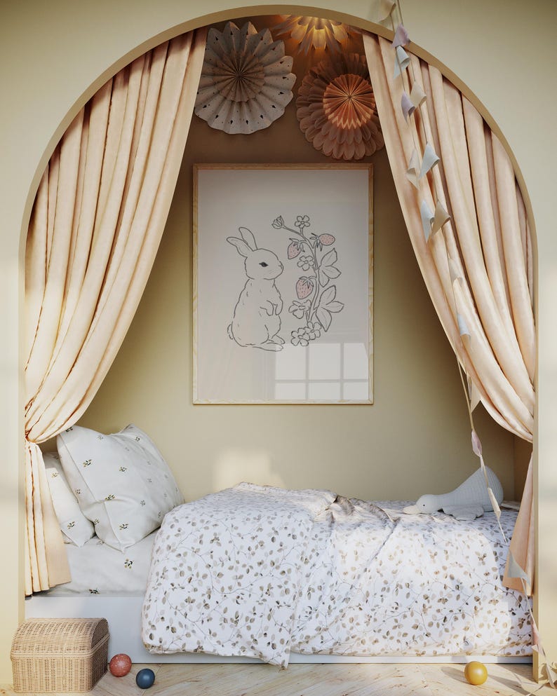 May include: A white bed with a floral patterned duvet cover and a white pillow with a floral pattern. The bed is in a nook with beige curtains and a framed print of a rabbit with strawberries.