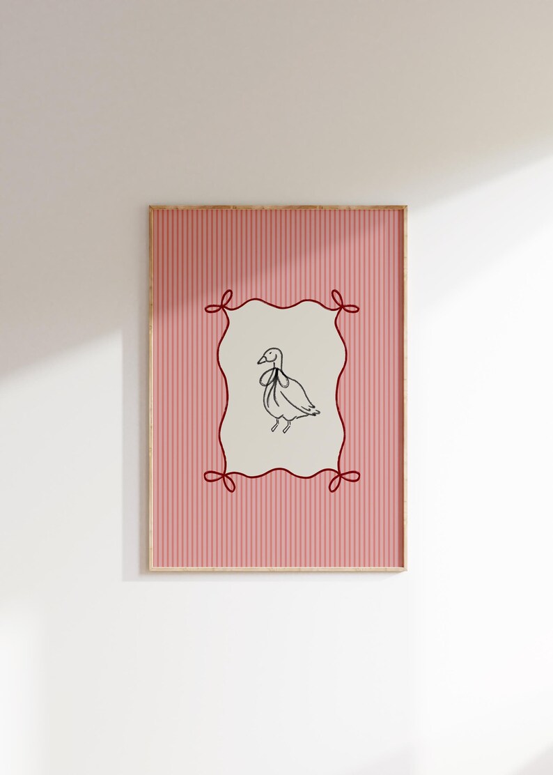 May include: A framed print with a pink and white striped background. A red ribbon frame surrounds a black and white line drawing of a bird with a bow tie.
