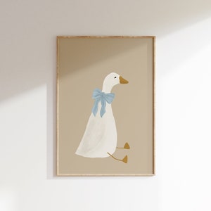 May include: A framed illustration of a white goose with a blue bow sitting on a beige background.
