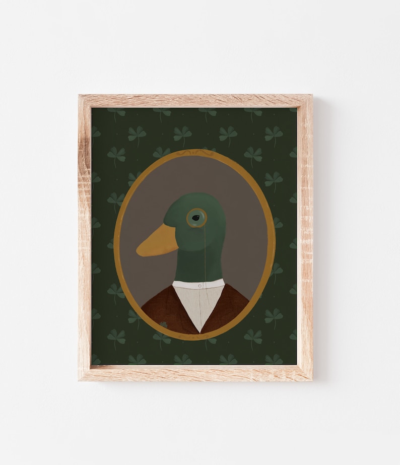 May include: A framed illustration of a duck wearing a monocle and a brown jacket, set against a green background with a clover pattern.