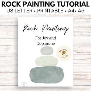 May include: A white printable art print with the text "Rock Painting Tutorial" at the top. The print features the words "Rock Painting For Joy and Dopamine" and a stack of three abstract painted rocks in shades of gray and green.