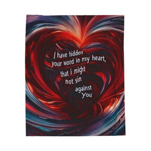 May include: A rectangular throw blanket with a heart-shaped design. The heart is composed of red, blue, and white swirling patterns. The text "I have hidden your word in my heart, that I might not sin against You" is printed on the blanket.