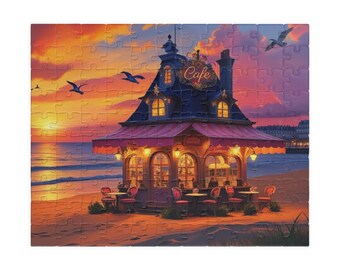 May include: A completed jigsaw puzzle depicting a seaside cafe at sunset. The cafe has a dark blue roof, red awning, and outdoor seating. The sky is a blend of orange, yellow, and pink, with seagulls flying above the ocean.