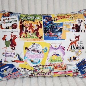 May include: Rectangular pillow featuring a collage of vintage Walt Disney movie posters. The pillow showcases iconic films like "Pinocchio," "Jungle Book," "Bambi," and "Cinderella" with vibrant colors and classic artwork. A decorative accent for Disney fans.