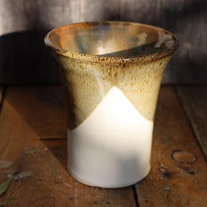 Oatmeal, white and brown stoneware vase applied in speckled pattern high fired