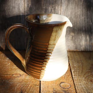 Brown, oatmeal and white stoneware jug glazed in a diagonal pattern
