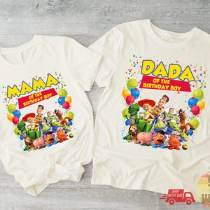 May include: Two white t-shirts with colorful graphics. One shirt says "MAMA OF THE BIRTHDAY BOY" and the other says "DADA OF THE BIRTHDAY BOY". Both shirts feature Toy Story characters and balloons.