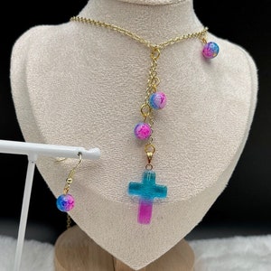 Dangly pink and blue cross charm necklace with Andara crystals with matching earrings
