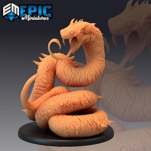 May include: An orange-toned miniature snake with an open mouth, revealing its tongue and fangs, coiled on a black base. The image includes the text "EM EPIC Miniatures". The snake is a detailed model.