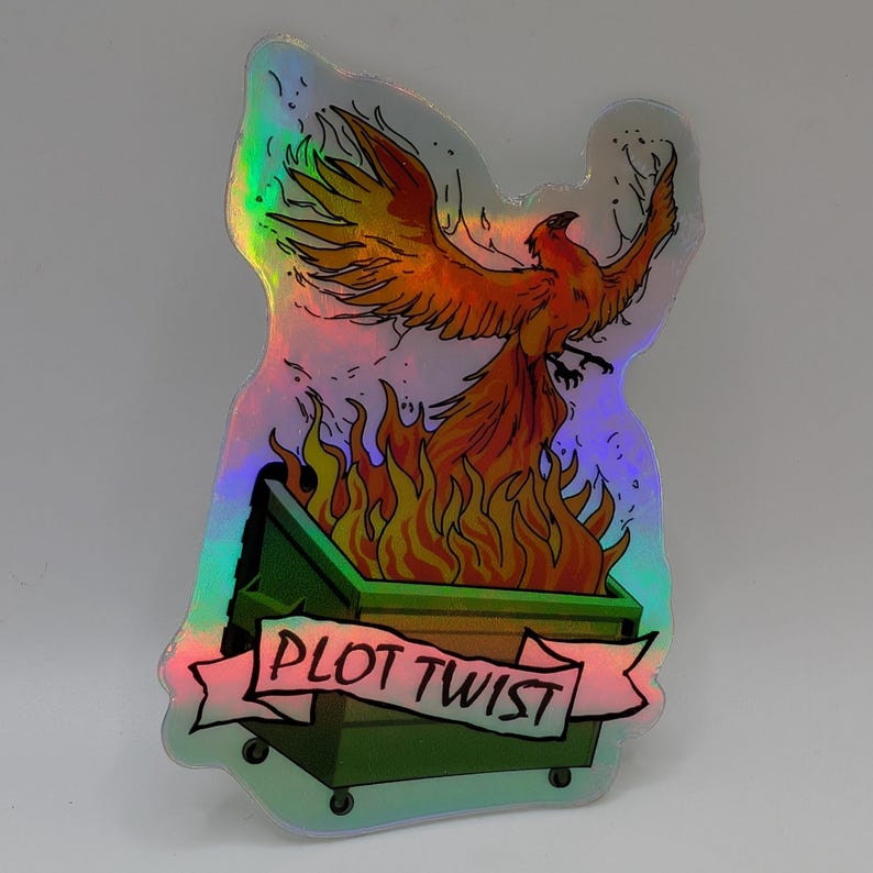 May include: Holographic sticker featuring a phoenix rising from a dumpster engulfed in flames. The phoenix is orange and red, with outstretched wings. The dumpster is green, and the banner reads "PLOT TWIST".