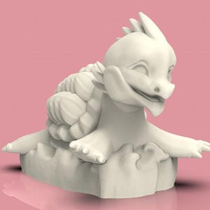 May include: A white ceramic figurine of a smiling dragon with a shell on its back. The dragon is perched on a rock-like base.