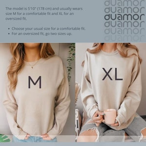 May include: Two beige sweatshirts, one with an "M" and the other with an "XL" printed on the front. The model is 5'10" (178 cm) and usually wears size M for a comfortable fit and XL for an oversized fit. Choose your usual size for a comfortable fit. For an oversized fit, go two sizes up.