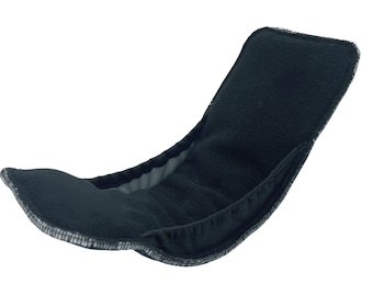 May include: Black cloth diaper insert with a soft, absorbent texture. The insert is designed to fit inside a cloth diaper cover.