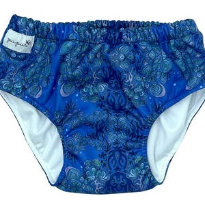 Peut inclure: Couche de bain réutilisable à motifs bleus et verts avec doublure blanche et étiquette "pupus".