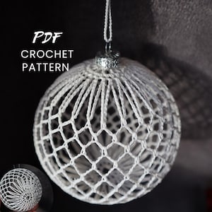 May include: A white crocheted Christmas ornament with a delicate, openwork design. The ornament is spherical and has a silver-colored cap and hanging loop. The text "PDF CROCHET PATTERN" is displayed in white letters.