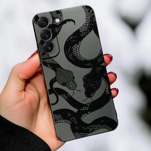 May include: A matte grey smartphone case featuring a repeating black snake pattern with detailed scales. The case has a cutout for a triple-lens camera system in the upper left corner and covers the back of a rectangular mobile device.