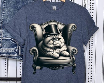 May include: A dark blue t-shirt featuring a graphic of a cat wearing a top hat and monocle, sitting in an armchair. The cat is white with black markings and has a bow tie.