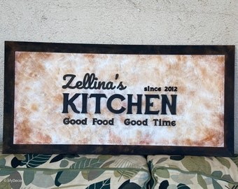 May include: Rustic wooden sign with a distressed white and brown background. The sign reads "Zellina's Kitchen since 2012 Good Food Good Time".