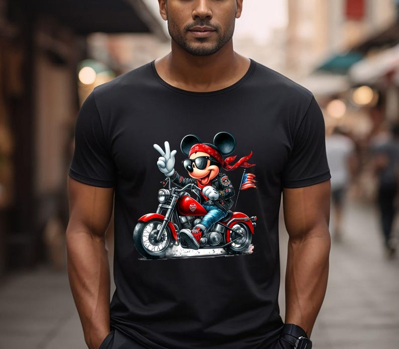 May include: Black t-shirt featuring a cartoon illustration of Mickey Mouse wearing sunglasses and a bandana, riding a motorcycle.